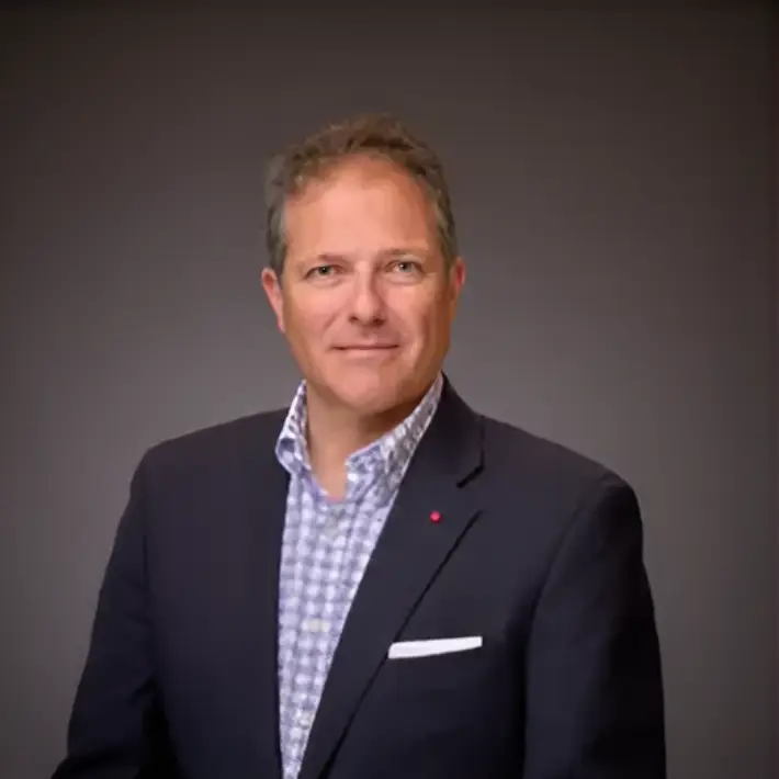 Middle-aged man smiling in blazer portrait